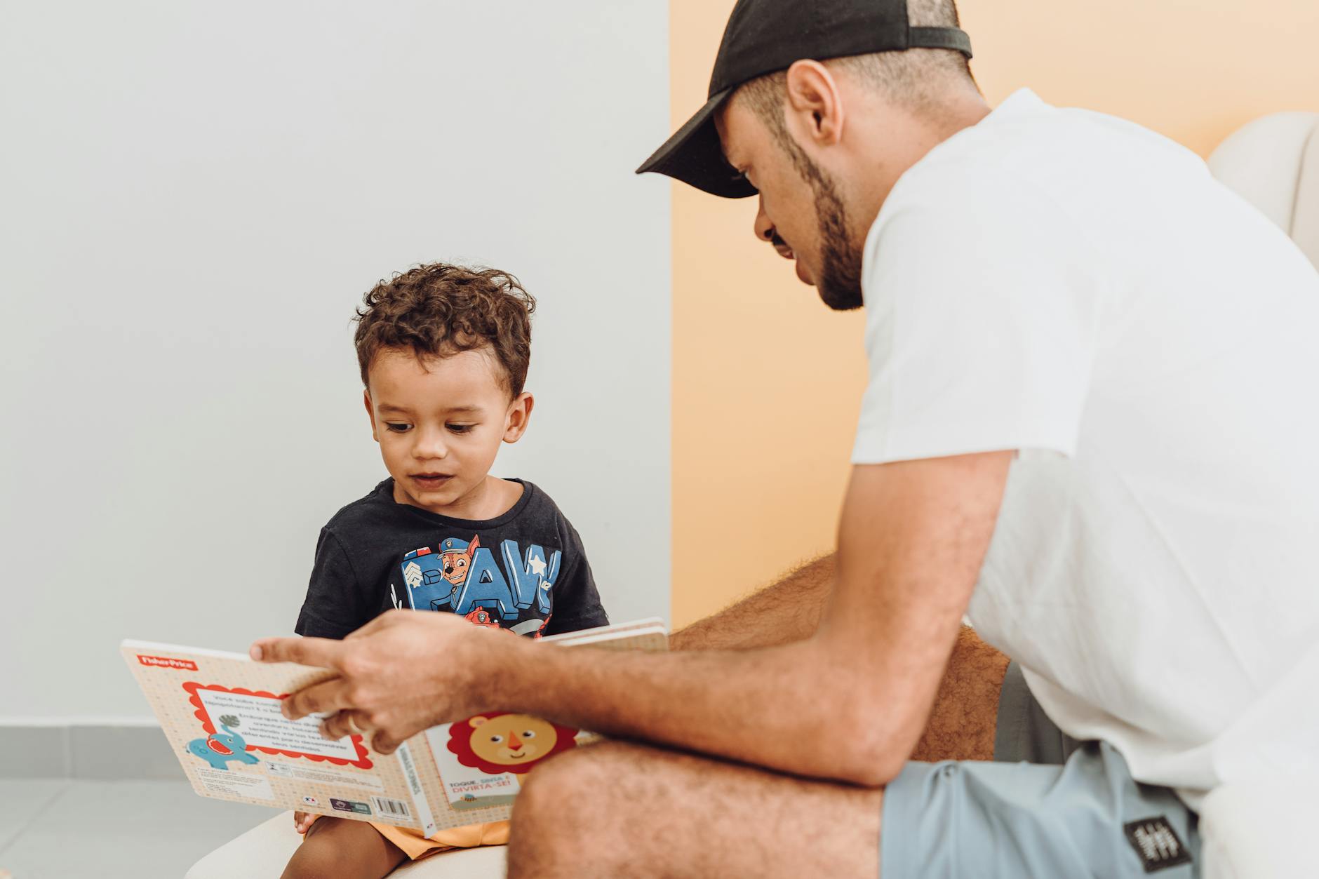 boy and father with book